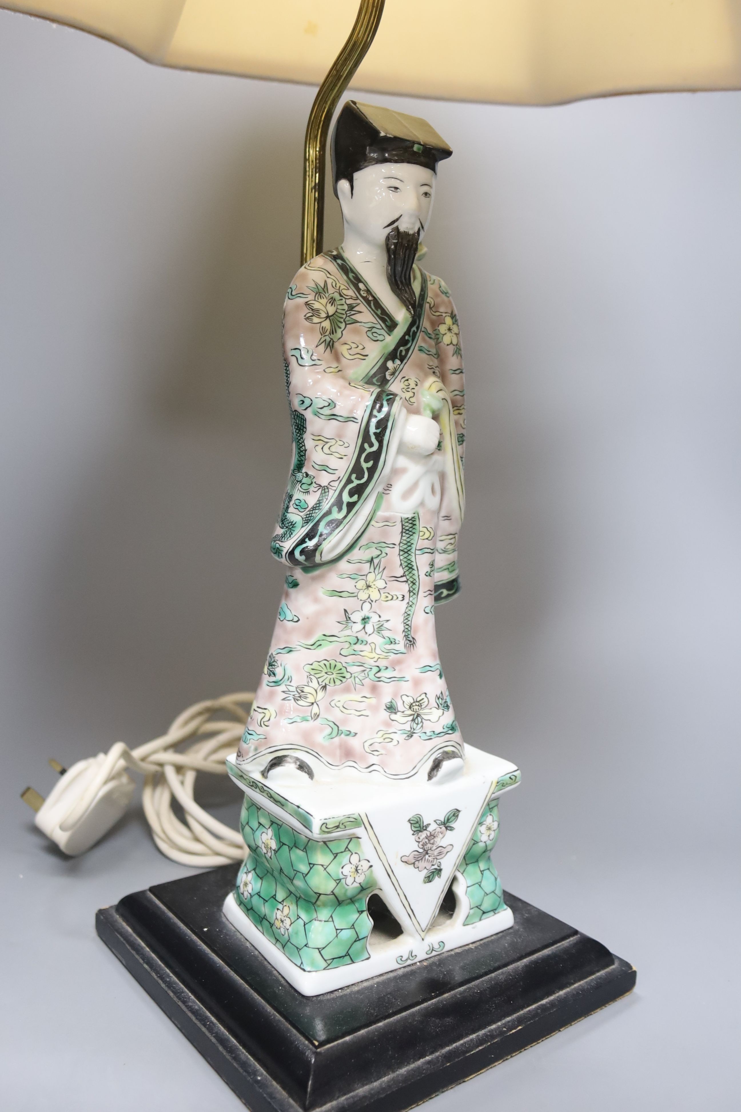 A Chinese famille verte figure of an immortal, mounted as a table lamp, height to fitting 49cm